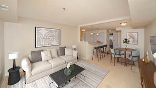 a living room and dining room with a couch and a table at Limestone Creek Apartment Homes, Alabama