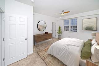 a large bedroom with a bed and a ceiling fan at Limestone Creek Apartment Homes, Madison, AL