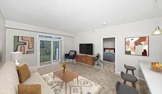 a living room with a 9 foot ceiling, couch and a tv at Limestone Creek Apartment Homes, Madison, AL