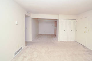 the living room and dining room of an empty house at Madeira Apartments, Kalamazoo, 49001