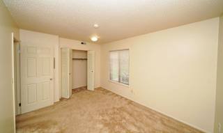 Bedroom with a large window and closet at Madeira Apartments, Kalamazoo, 49001