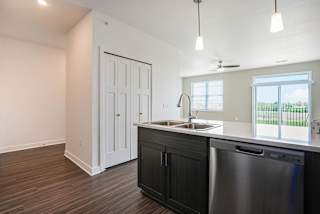 an empty kitchen with a sink and a window at Meadowbrooke Apartment Homes, Michigan, 49512