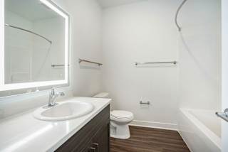 a bathroom with a sink toilet and a mirror at Meadowbrooke Apartment Homes, Grand Rapids