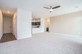 an empty living room with a ceiling fan at Meadowbrooke Apartment Homes, Grand Rapids