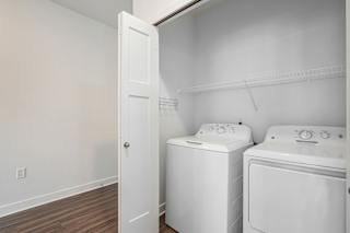 a white laundry room with two washes and a dryer at Meadowbrooke Apartment Homes, Michigan, 49512
