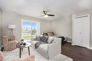 a living room with a couch and a bed at Meadowbrooke Apartment Homes, Grand Rapids, Michigan