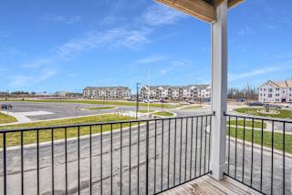 the view from the balcony of a building with a parking lot at Meadowbrooke Apartment Homes, Grand Rapids, MI, 49512