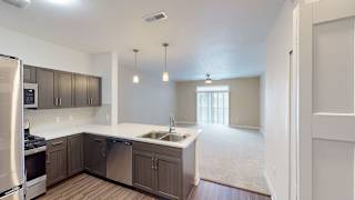 an empty kitchen and living room with wood flooring at Meadowbrooke Apartment Homes, Michigan, 49512