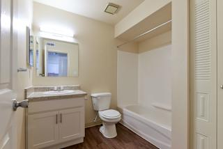 a bathroom with a sink toilet and a bath tub at Old Monterey Apartments, Springfield