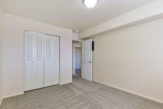 a living room with white doors and a door to a hallway at Old Monterey Apartments, Springfield