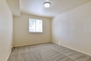an empty room with carpet and a window at Old Monterey Apartments, Springfield, MO