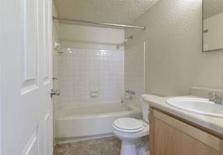 a bathroom with a sink toilet and a bath tub at Old Monterey Apartments, Springfield, MO, 65807