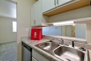 a kitchen with a sink and a counter top at Old Monterey Apartments, Springfield