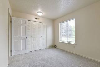 an empty room with a door and a window at Old Monterey Apartments, Springfield, MO, 65807