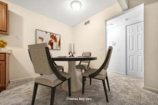 a dining room with a table and chairs at Timberbrook Apartments, Illinois, 61614