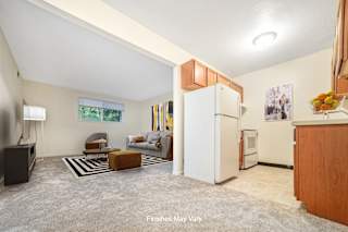 a kitchen and living room in a small apartment at Timberbrook Apartments, Peoria, Illinois