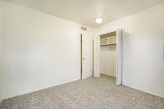 Bedroom with a closet at Newport Village Apartments in Portage, MI