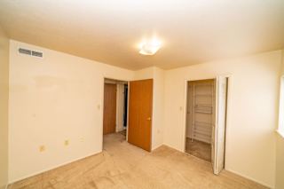 an empty living room with a closet and a door to a bathroom at North Pointe Apartments, Elkhart, IN
