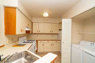 an empty kitchen with white appliances and white cabinets at North Pointe Apartments, Indiana, 46514