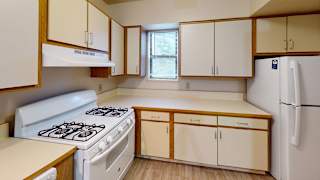 an empty kitchen with a stove and refrigerator at North Pointe Apartments, Elkhart, IN