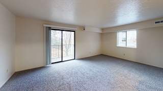 an empty living room with a sliding glass door to a balconyat North Pointe Apartments, Indiana, 46514