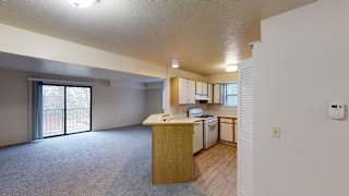 a kitchen with an island in the middle of a living roomat North Pointe Apartments, Elkhart, IN