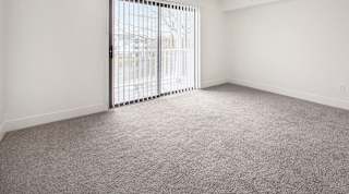 living room with a sliding glass door at North Pointe Apartments in Elkhart, IN