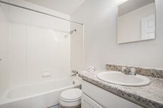 a renovated bathroom with a sink toilet and a bath tub at Normandy Village Apartments, Michigan City, 46360