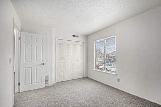 an empty bedroom with a window and a door at Normandy Village Apartments, Michigan City, Indiana