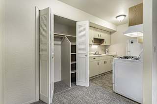 a kitchen with white appliances and a closet at Normandy Village Apartments, Michigan City, 46360