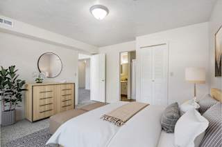 A bedroom with a large bed and ensuite bathroom at North Pointe Apartments, Elkhart, IN, 46514