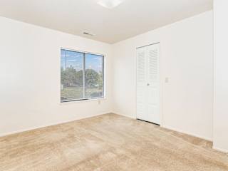 an empty room with a window and a walk-in closet at Oak Shores Apartments, Oak Creek, 53154