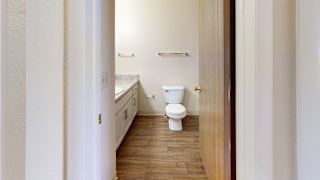 an empty bathroom with a toilet and a sink  at Oak Shores Apartments, Oak Creek, WI