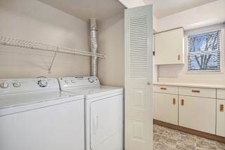 A laundry area with a washer and dryer at Pine Knoll Apartments, Battle Creek, MI