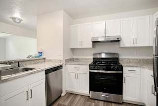 A kitchen with white cabinets and stainless steel appliances at Pine Knoll Apartments, Battle Creek, 49014