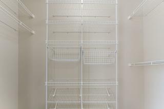 walk in closet with wardrobe organizers at Hunters Pond Apartment Homes, Illinois, 61820