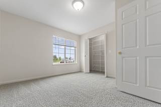 spacious bedroom with a closet and a large window at Hunters Pond Apartment Homes, Champaign, Illinois