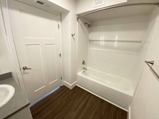 A bathroom with a bathtub and shower at Green Ridge Apartments, Michigan, 49544