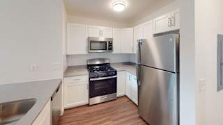 a kitchen with white cabinets and hard surface flooring at Green Ridge Apartments, Grand Rapids, MI, 49544