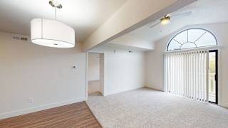 an empty living room with white walls and a large window at Green Ridge Apartments, Grand Rapids, Michigan