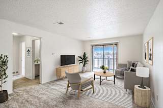a living room with a slider to a balcony at Seville Apartments, Kalamazoo, MI, 49009