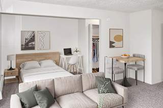 a living room with a sleeping area at Seville Apartments, Kalamazoo, 49009
