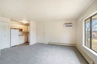 A large, open living room and kitchen area at Seville Apartments, Kalamazoo