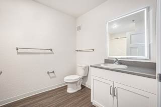 a bathroom with hard-surface flooring and a lighted mirror  at Signature Pointe Apartment Homes, Athens, AL, 35611