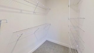 walk in closet with wardrobe organizers at Signature Pointe Apartment Homes in Athens, AL