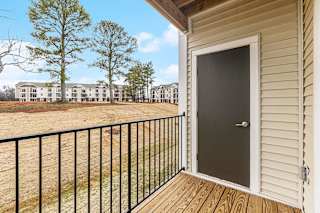 Private balcony with enclosed storage overlooking apartment community  at Signature Pointe Apartment Homes, Athens, AL, 35611