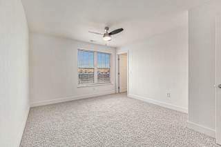 Large bedroom with a ceiling fan and a large window  at Signature Pointe Apartment Homes, Athens, Alabama