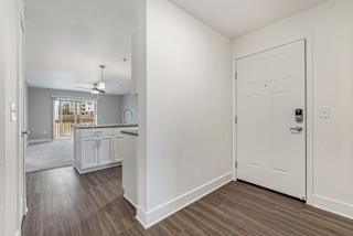 Entry to kitchen and living room with hard surface floors  at Signature Pointe Apartment Homes, Athens, AL, 35611