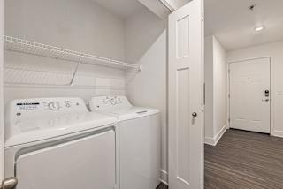 a washer and dryer in a laundry room  at Signature Pointe Apartment Homes, Athens, 35611