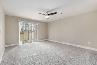 living room with a ceiling fan and a slider to a balcony  at Signature Pointe Apartment Homes, Athens, 35611